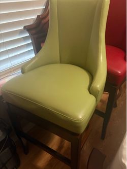 Light green and red leather upholstery accent chair with wood frame