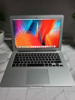 Silver MacBook Air 13-inch (Mid 2012) running macOS High Sierra. Specs visible on screen: 1.8GHz Intel Core i5, 8GB 1600MHz DDR3 RAM, Intel HD Graphic