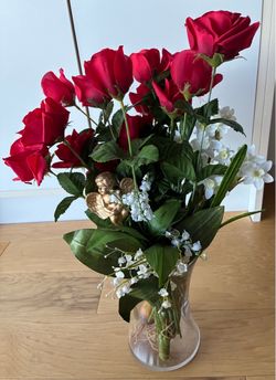 Artificial floral arrangement 20” tall in a glass vase 8” tall.