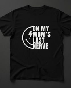 "On My Mom's Last Nerve" T-Shirt
​This is a classic-fit crew neck t-shirt in black, featuring a bold, graphic print in white.
​Design Focus: The shirt