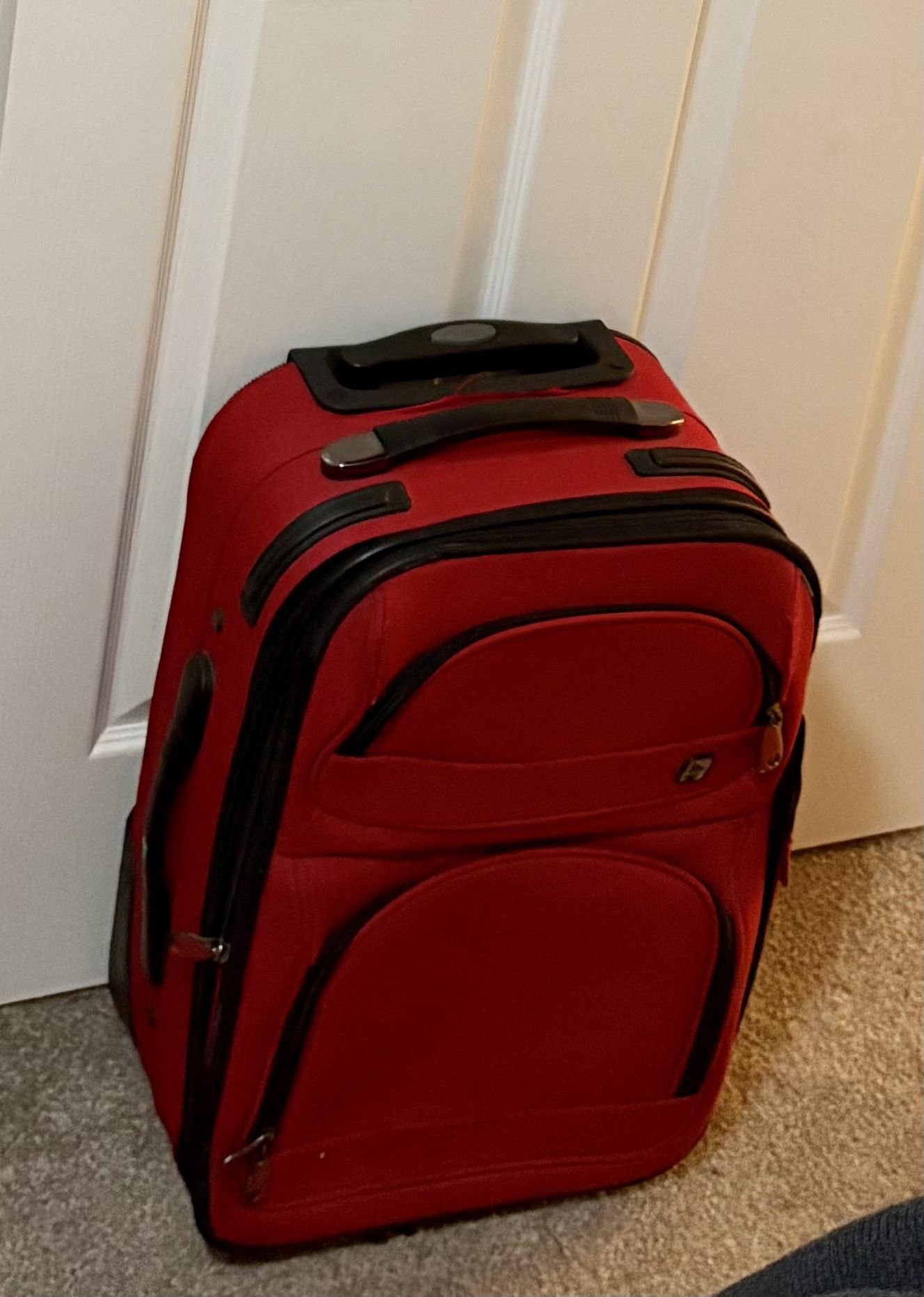 Red Suitcase On Wheels And Luggage Bag