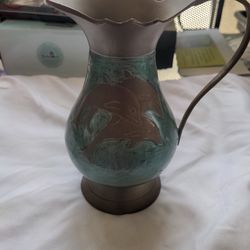 Brass Vase Embossed With Dolphins On It.