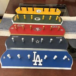 Hand crafted  6 peg accessory holders… Ball caps, keys, lanyards etc…official team colors/decals… various pro sports teams. Some may have been sold… 2