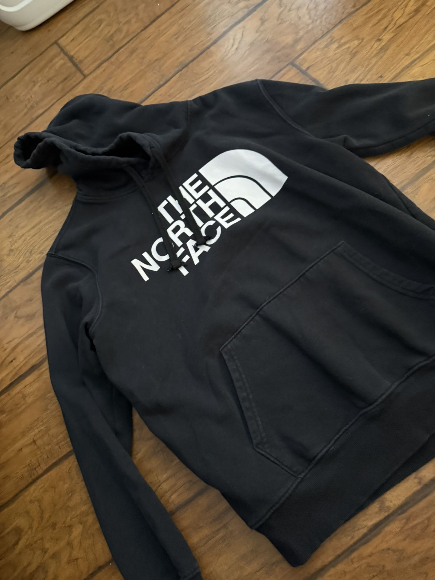 The North Face black pullover hoodie with a white logo.  Medium on tag