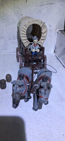 2 Vintage 70's Cast iron Prairie schooner chewing tobacco wagon.