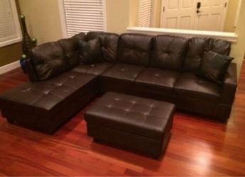 Brown leather sectional couch and ottoman