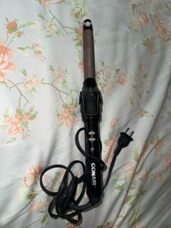 Conair Instant Heat 3/4-inch curling iron, recognizable by the black handle and silver-toned barrel
