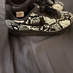 This is a Nike Air Force 1 Foamposite Pro Cup "Glow Snakeskin" sneaker. 