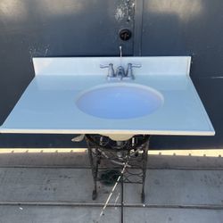 Bathroom sink and top, complete with foucet and hoses, 34” wide by 22” deep, only $ 75.00.