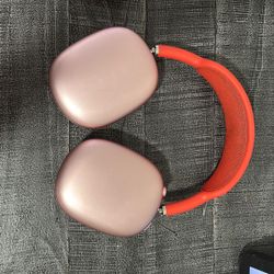 Apple AirPods Max in the Pink (coral/red) color with matching smart case.