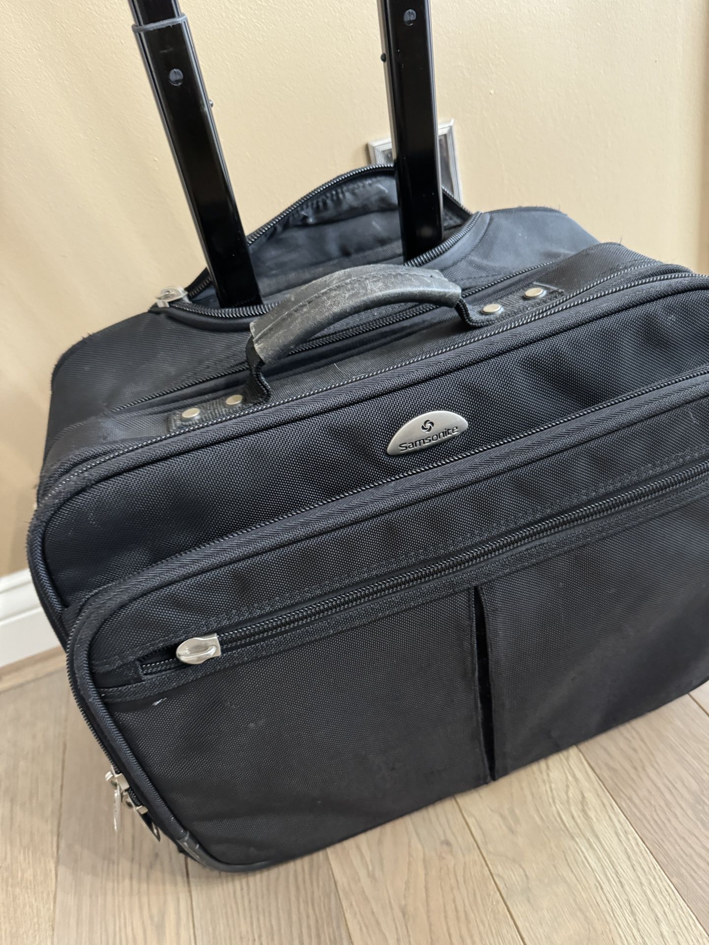 Samsonite Rolling Laptop Bag in good shape! Tons of storage and handle can also stow away in bag.