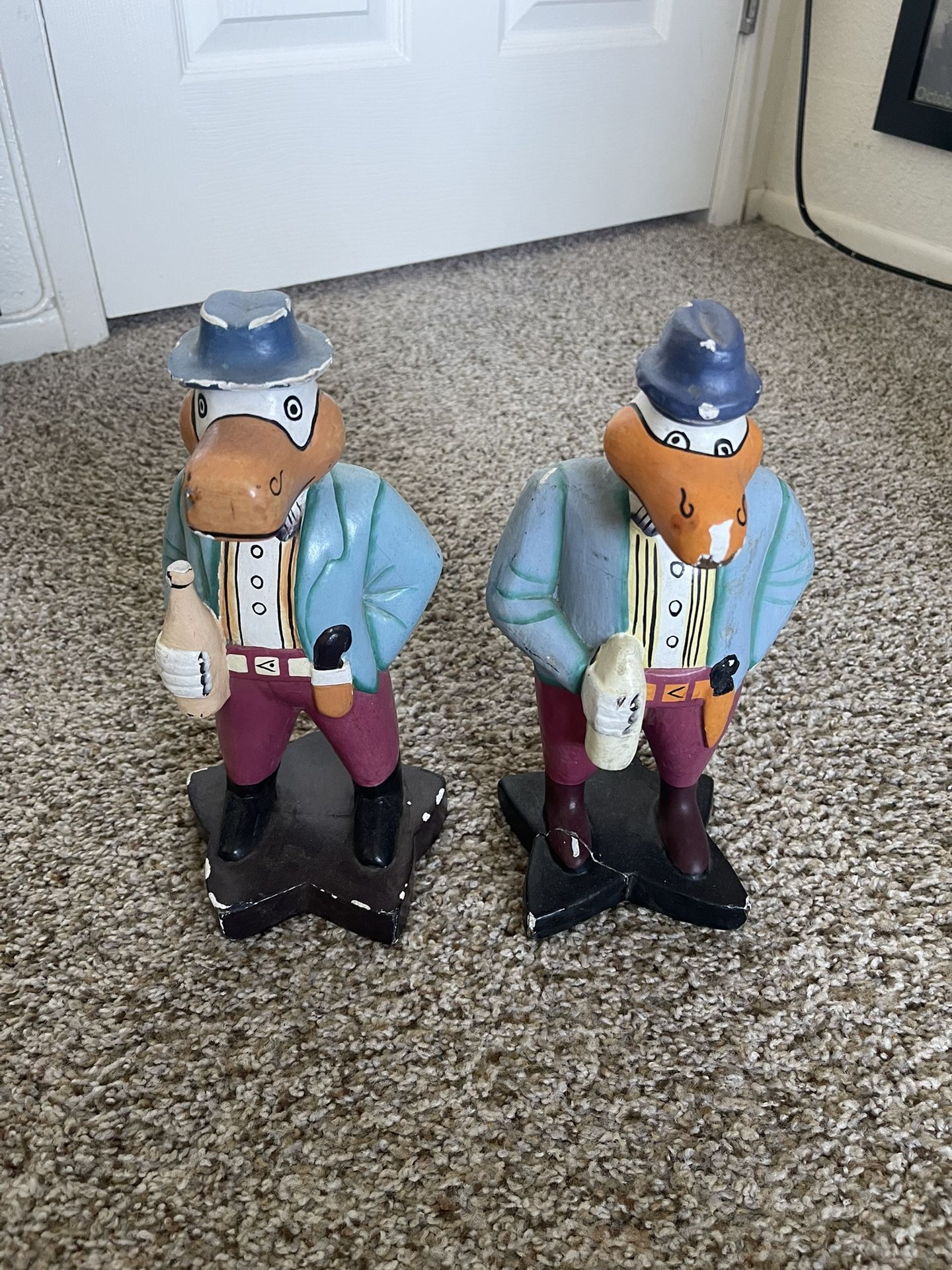 These are hand-carved and painted duck figurines, often referred to as "Albert the Duck" or similar styles of wooden duck decor.