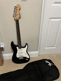 Squier Strat by Fender Electric Guitar + Fender Champ 15 Amp + Fender Gig Bag