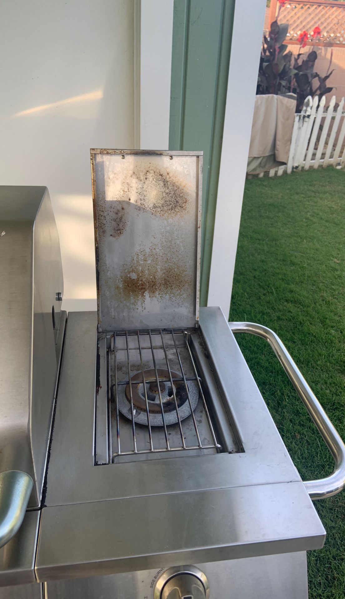 Stainless steal JennAir BBQ with stainless grills and a canvas cover