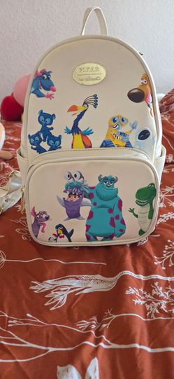 Her Universe mini backpack with pixar characters.