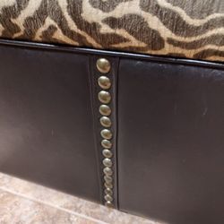 FAUX LEATHER WITH NAILHEAD TRIM AND ZEBRA CUSHIONED TOP STORAGE BENCH