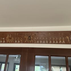 Decorative wooden panel featuring a detailed procession scene. 4’ x 6”