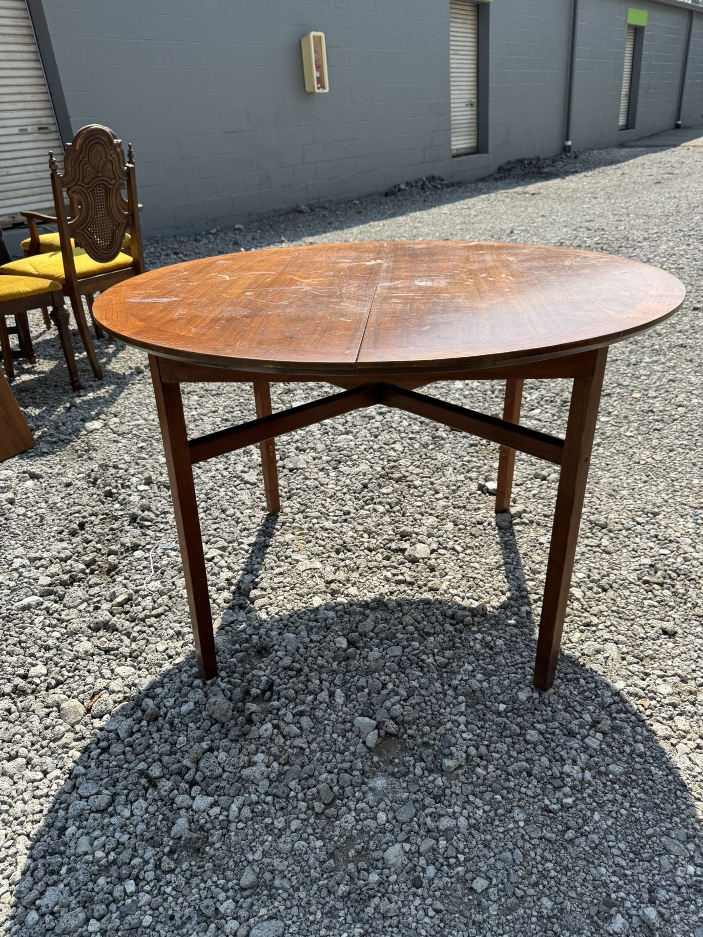 MCM Extending Oval Dining Table in Teak . Needs refinishing 42” wide 42” deep 29” tall Leaf 42” long 18” deep