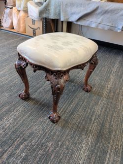 Chippendale-style carved mahogany stool featuring cabriole legs with upholstered seat