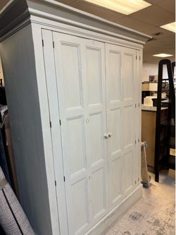 Kate Madison French Country furniture piece features a linen cupboard design with distinct inset beveled panels and crown molding -