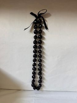 Black Hawaiian Kukui Nut Lei Necklace Tied with a Black Ribbon