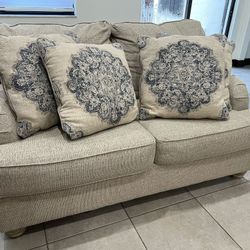 Beige Two-Seater Couch with Decorative Pillows - Gently Used