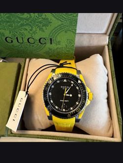 GUCCI Diver 136.3 Black Dial Yellow Rubber Strap Man’s Watch Ref. YA136319   New never worn comes with tags box and papers  This one retails over $1,2