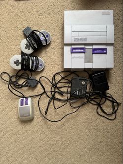 Super Nintendo console with games and manuals