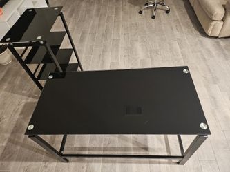 Rectangular desk in perfect condition, made of black glass. It comes with a bookcase or other shelves in good condition.