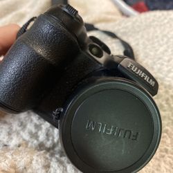 Fujifilm FinePix S1000fd 10MP Digital Camera – 12X Zoom + Strap & Lens Cap (Uses 4 AA Batteries)