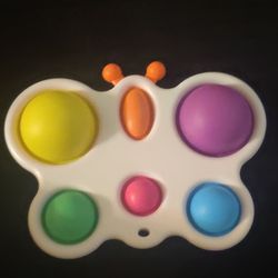 Dimple poppet fidget toy yellow orange purple pink green and white