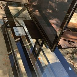 Tv.   Tv glass stand and lawn mower.