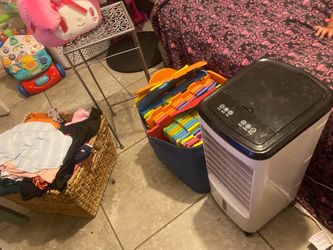 Baby clothes an puzzle an lil ac an stand an lil basket