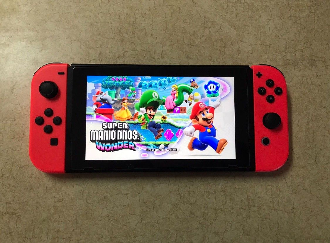 NINTENDO SWITCH V2 with 125 SWITCH GAMES MARIO KART,MARIO PARTY,POKEMON,ZELDA and More