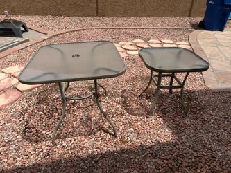 Two glass top outdoor patio tables