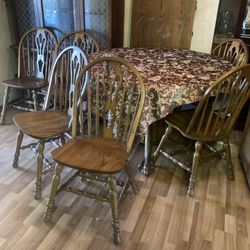 Dinette table wood with six chairs and a hutch An extra leaf