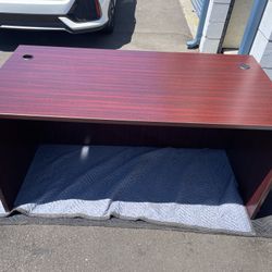 wooden office desk with cable management holes.