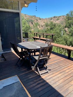 Wooden patio table with four chairs. Extendable.