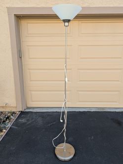 Silver floor lamp with glass shade