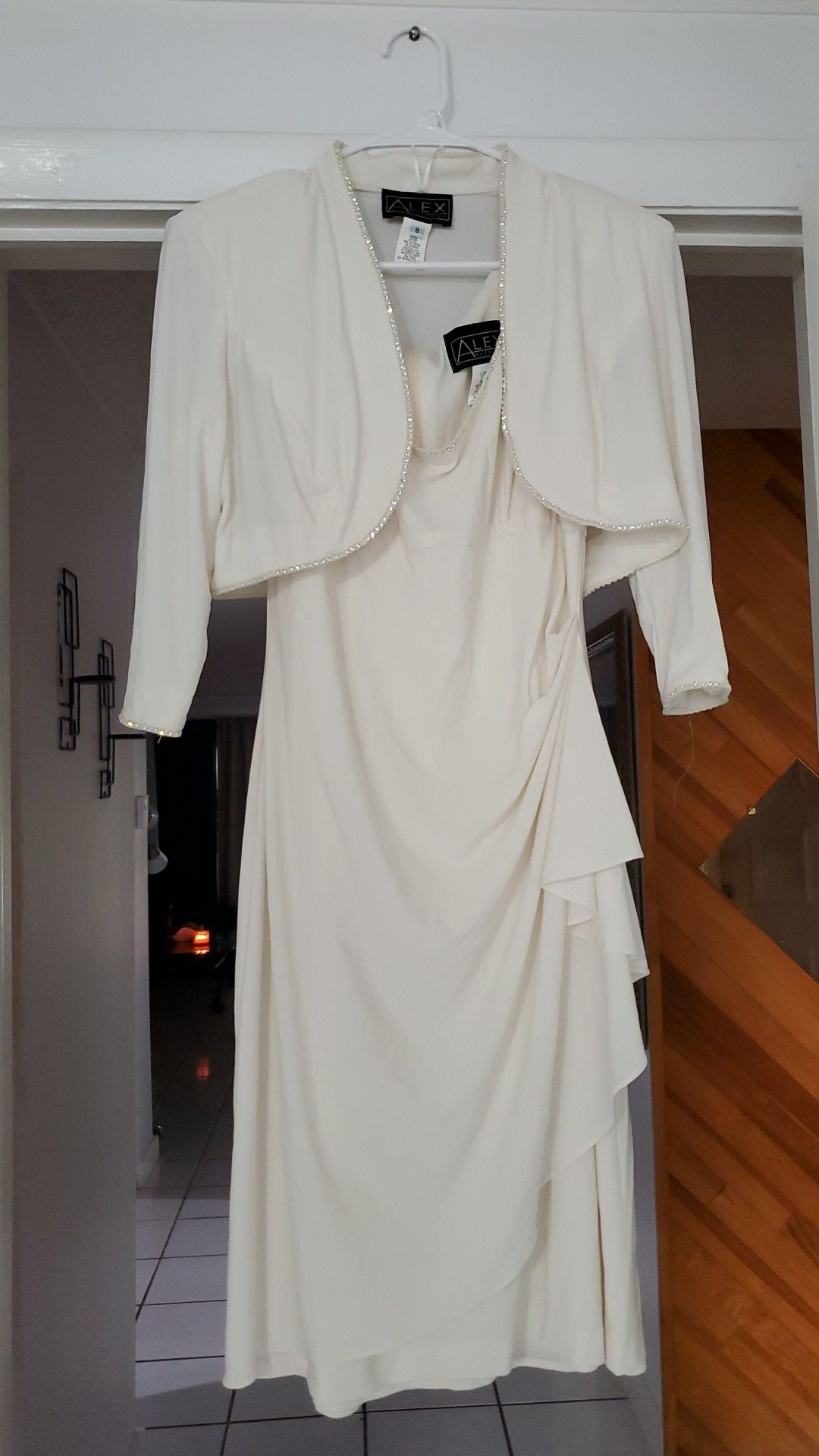 Off white color Gown, Size medium, with matching jacket, beading trim on neckline of gown and jacket.