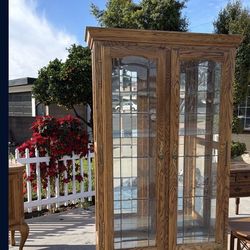 Tall oak curio cabinet