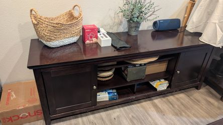 Table with multiple shelves and sliding doors