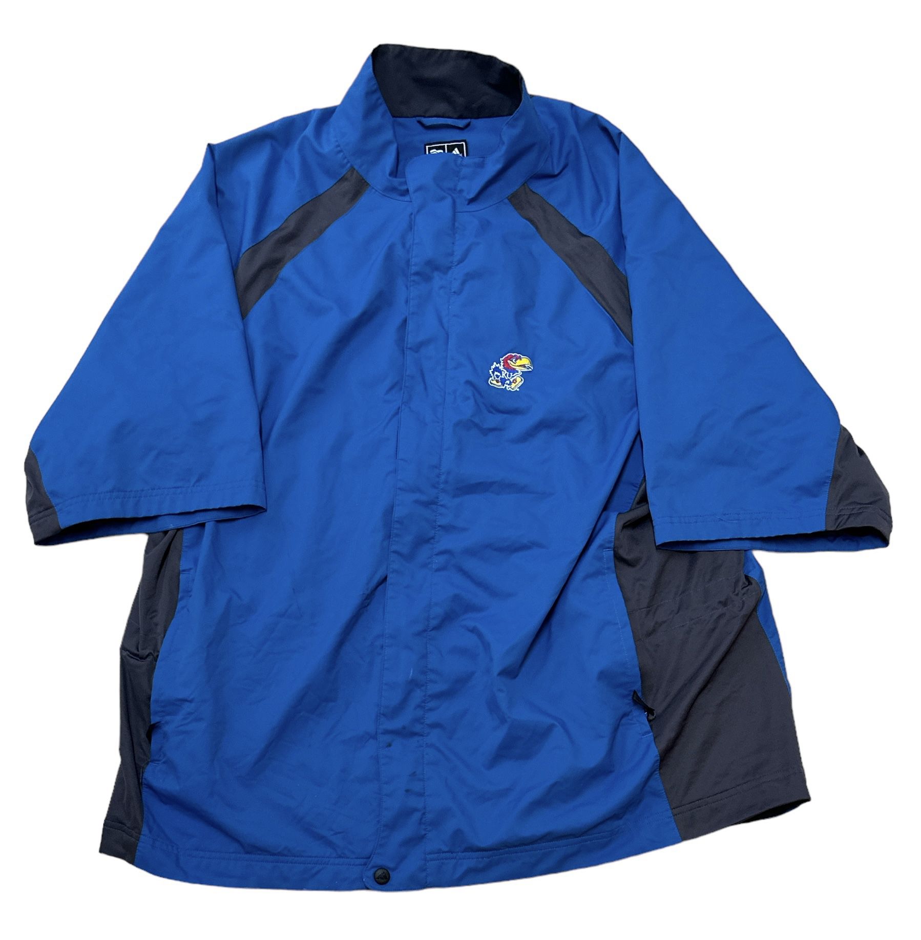 Brand: Adidas KU Short Sleeve ClimaProof Storm Windbreaker Jacket  Color: Colorblock Blue, Black  Size XXL Jacket has 5 small dot stains as shown on p