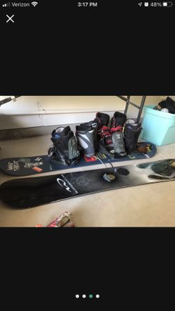 Snowboards And Three Pairs Of Boots