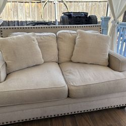 Beige love seat for sale