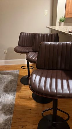 3 brown padded adjustable barstool chairs