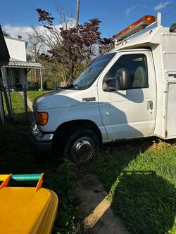 white Ford E-350 Super Duty service truck with a Stahl utility body.