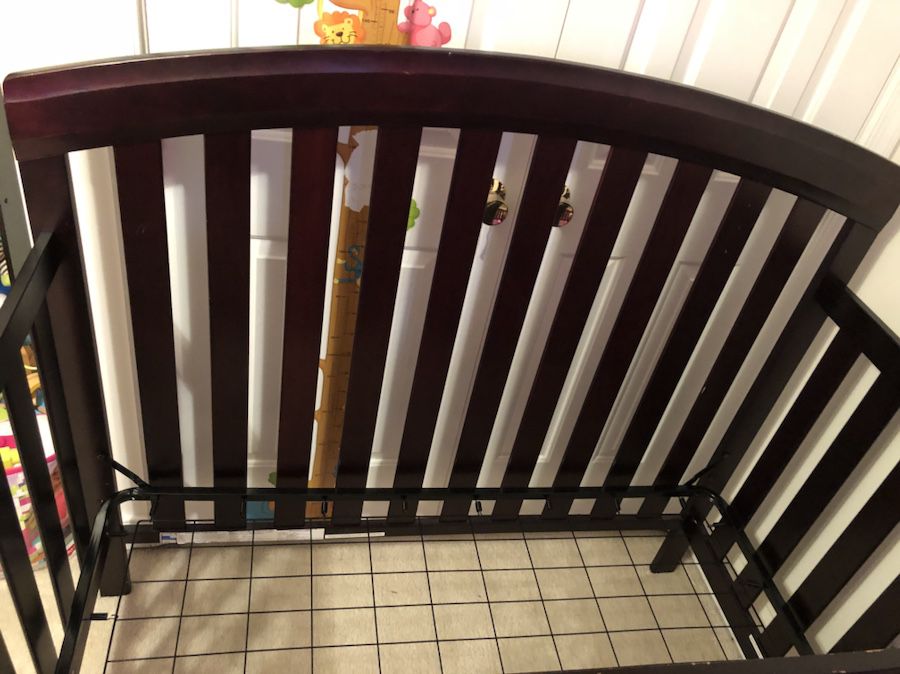 Babys brown wooden crib