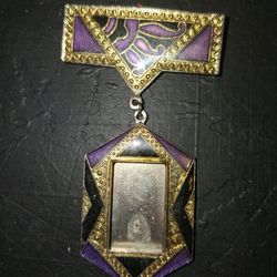 vintage Art Deco-style enamel photo frame brooch, a type of costume jewelry designed to hold a small, personal photograph