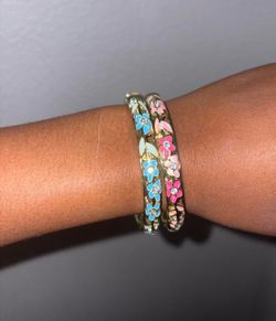 Gold bangles with blue and pink flowers
